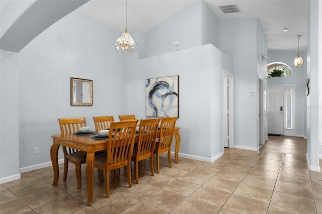 242 Saragossa Ave, Davenport, FL 33897 - dining space with high vaulted ceiling, a chandelier, and light tile patterned floors