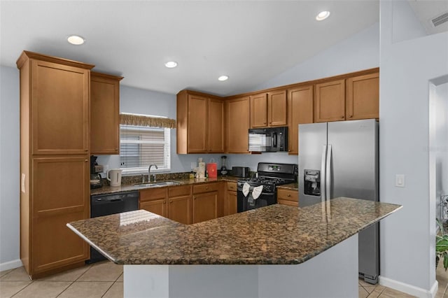 242 Saragossa Ave, Davenport, FL 33897 - kitchen featuring black appliances, light tile patterned floors, brown cabinets, dark stone countertops, and recessed lighting