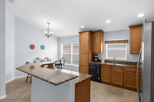 242 Saragossa Ave, Davenport, FL 33897 - kitchen with dishwasher, freestanding refrigerator, light tile patterned flooring, brown cabinets, and recessed lighting