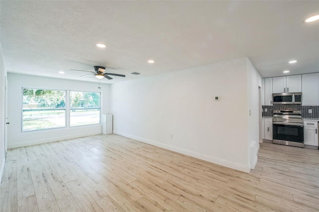 4212 Harry Dr, Fruitland Park, FL 34731 - unfurnished living room with ceiling fan, recessed lighting, and light wood-style floors