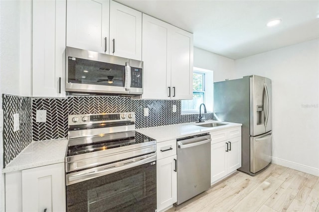 4212 Harry Dr, Fruitland Park, FL 34731 - kitchen featuring stainless steel appliances, light wood-style floors, light countertops, and tasteful backsplash