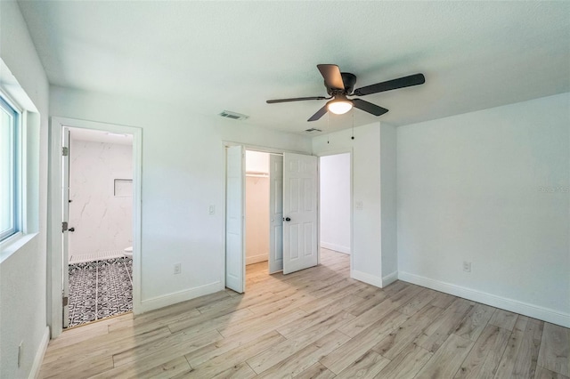 4212 Harry Dr, Fruitland Park, FL 34731 - unfurnished bedroom featuring wood finished floors, ceiling fan, and ensuite bath