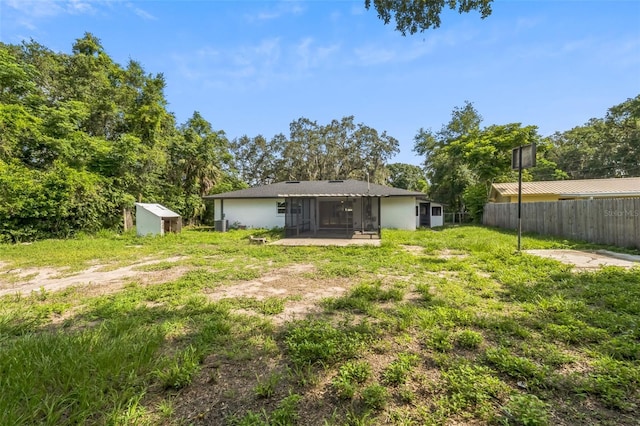 4212 Harry Dr, Fruitland Park, FL 34731 - rear view of property featuring a sunroom and a shed