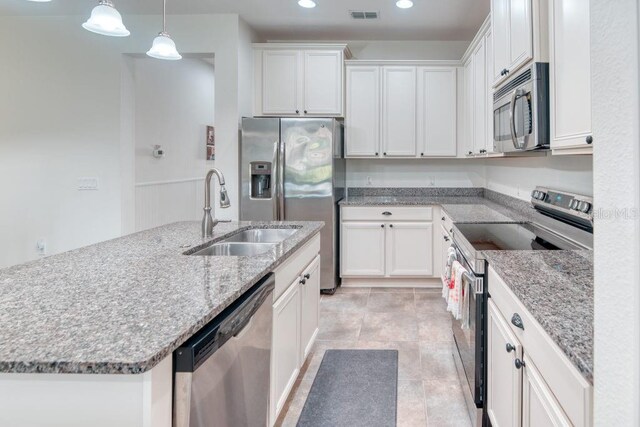 3432 Fallbrook Dr, Poinciana, FL 34759 - kitchen with appliances with stainless steel finishes, white cabinets, recessed lighting, light stone countertops, and pendant lighting