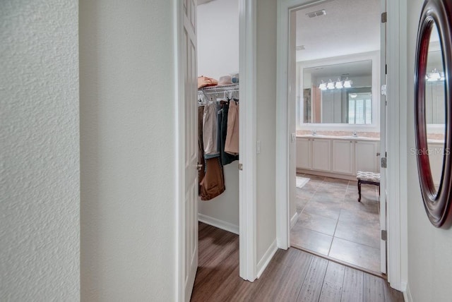 3432 Fallbrook Dr, Poinciana, FL 34759 - hallway featuring light wood-style flooring and baseboards