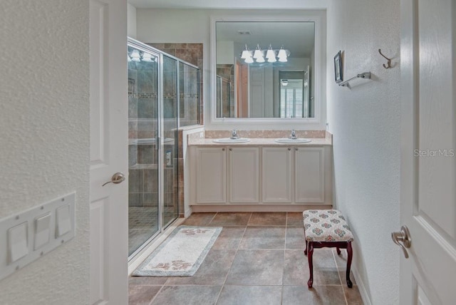 3432 Fallbrook Dr, Poinciana, FL 34759 - full bath featuring double vanity, a shower stall, a textured wall, and tile patterned floors