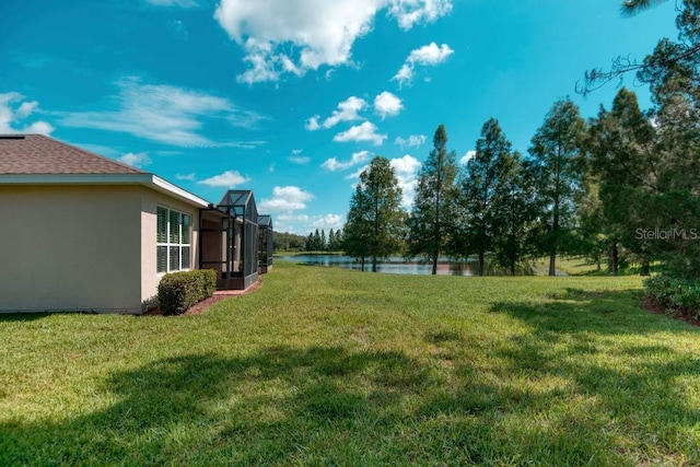 3432 Fallbrook Dr, Poinciana, FL 34759 - view of grassy yard with a water view and glass enclosure