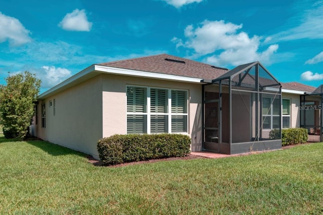 3432 Fallbrook Dr, Poinciana, FL 34759 - back of house with stucco siding, a yard, and a lanai