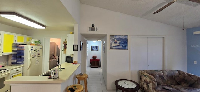 5291 Images Cir Unit 302, Kissimmee, FL 34746 - kitchen with white appliances, tile patterned flooring, light countertops, a peninsula, and ceiling fan
