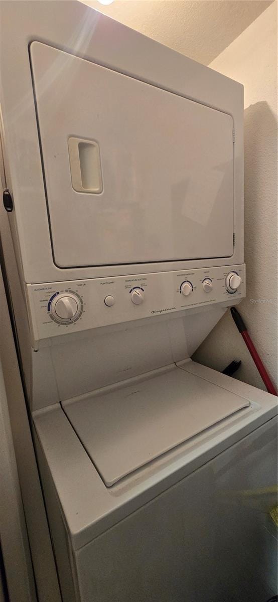 5291 Images Cir Unit 302, Kissimmee, FL 34746 - laundry room featuring stacked washer / dryer
