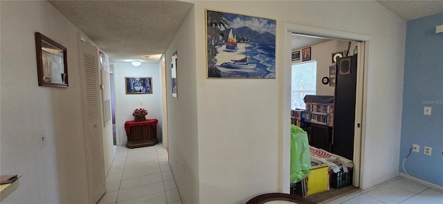 5291 Images Cir Unit 302, Kissimmee, FL 34746 - hall with light tile patterned floors and a textured ceiling