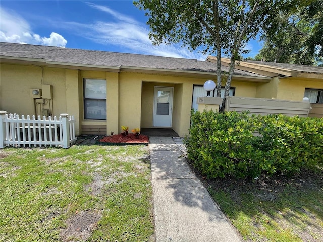 12161 Sandal Creek Way, Orlando, FL 32824 - entrance to property with stucco siding and roof with shingles