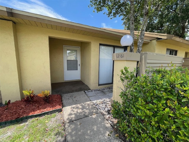 12161 Sandal Creek Way, Orlando, FL 32824 - doorway to property featuring stucco siding