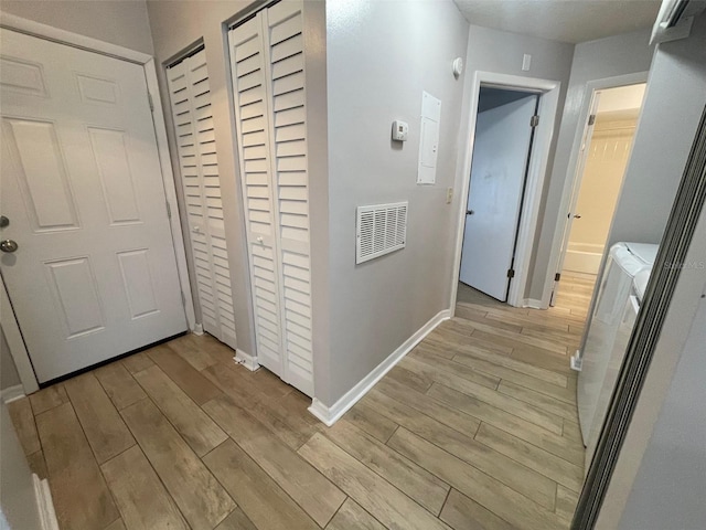 12161 Sandal Creek Way, Orlando, FL 32824 - hall featuring washing machine and dryer and light wood-type flooring