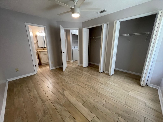 12161 Sandal Creek Way, Orlando, FL 32824 - unfurnished bedroom featuring multiple closets, washer and clothes dryer, light wood-style floors, and ceiling fan