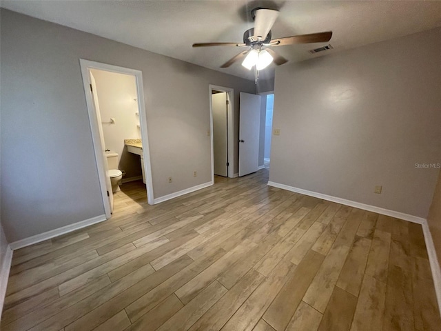 12161 Sandal Creek Way, Orlando, FL 32824 - unfurnished bedroom featuring wood finished floors, ensuite bathroom, and ceiling fan