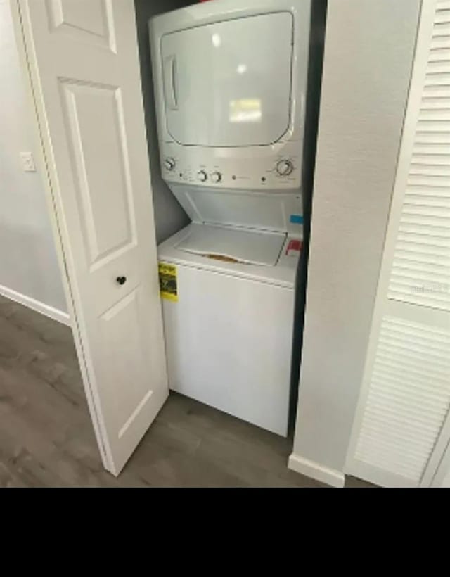 838 E Lime St, Lakeland, FL 33801 - laundry area with estacked washer and dryer and wood finished floors