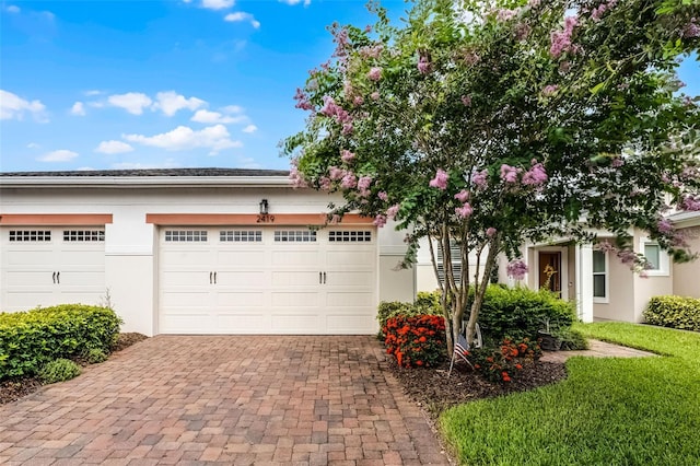 2419 Datura Loop, Saint Cloud, FL 34772 - view of front of home featuring decorative driveway, stucco siding, and an attached garage