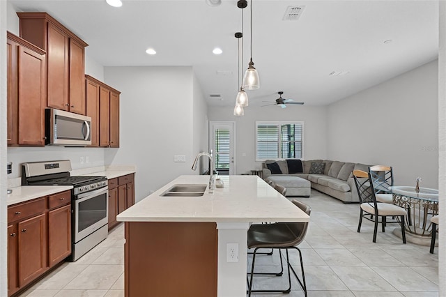 2419 Datura Loop, Saint Cloud, FL 34772 - kitchen with appliances with stainless steel finishes, light tile patterned floors, ceiling fan, recessed lighting, and light countertops