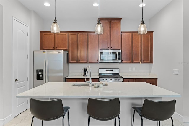 2419 Datura Loop, Saint Cloud, FL 34772 - kitchen featuring stainless steel appliances, light tile patterned flooring, a breakfast bar, a kitchen island with sink, and recessed lighting