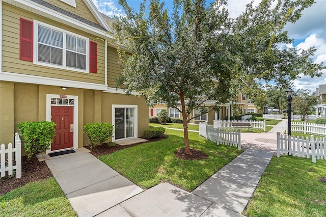 2602 Lodi Cir Unit 107, Kissimmee, FL 34746 - view of front facade featuring stucco siding
