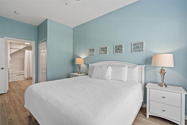 2602 Lodi Cir Unit 107, Kissimmee, FL 34746 - bedroom featuring wood finished floors, ensuite bathroom, and a closet