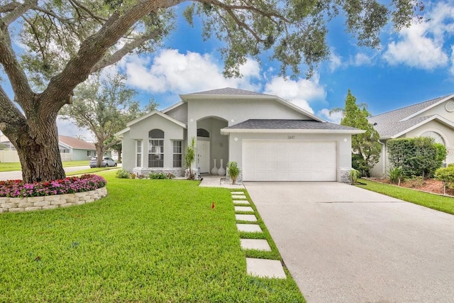 2647 Heron Landing Ct, Orlando, FL 32837 - single story home with stucco siding, an attached garage, driveway, and a front lawn