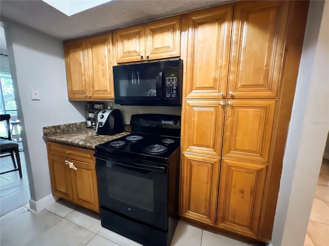 4755 S Texas Ave Unit 4755D, Orlando, FL 32839 - kitchen with black appliances, light tile patterned flooring, and brown cabinets