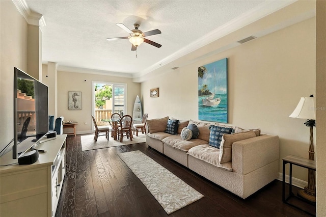 501 Mirasol Cir Unit 213, Celebration, FL 34747 - living room featuring ornamental molding, ceiling fan, dark wood-style floors, and a textured ceiling