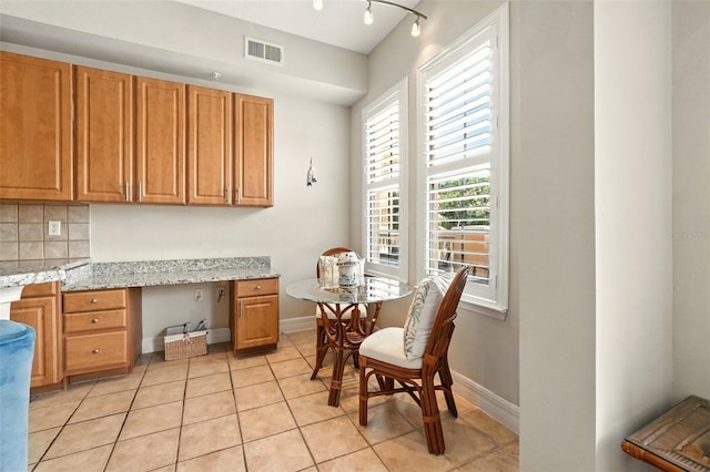 501 Mirasol Cir Unit 213, Celebration, FL 34747 - dining space featuring built in desk and light tile patterned floors