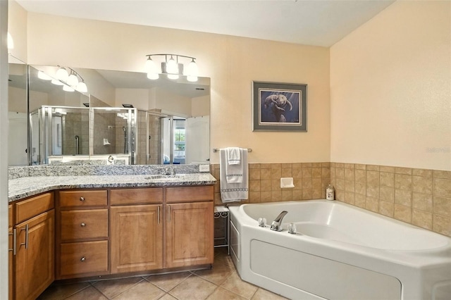 501 Mirasol Cir Unit 213, Celebration, FL 34747 - full bathroom with a shower stall, vanity, a bath, and tile patterned flooring