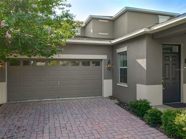 15150 Evergreen Oak Loop, Winter Garden, FL 34787 - view of front of home featuring stucco siding and decorative driveway