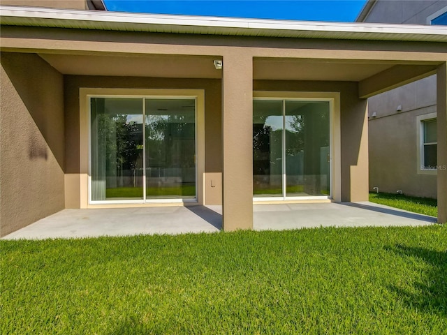 15150 Evergreen Oak Loop, Winter Garden, FL 34787 - doorway to property with a patio area, a lawn, and stucco siding
