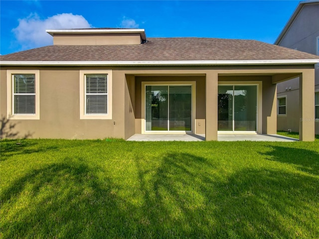 15150 Evergreen Oak Loop, Winter Garden, FL 34787 - rear view of property featuring a lawn, roof with shingles, stucco siding, and a patio area