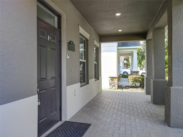 15150 Evergreen Oak Loop, Winter Garden, FL 34787 - property entrance featuring covered porch and stucco siding