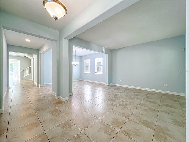 15150 Evergreen Oak Loop, Winter Garden, FL 34787 - unfurnished room with light tile patterned flooring, a chandelier, and stairs