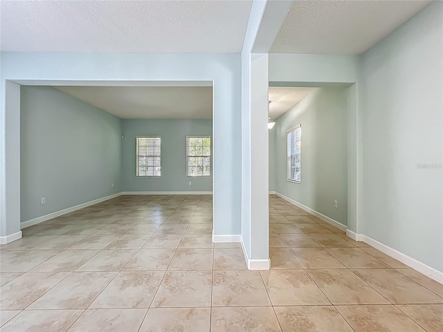 15150 Evergreen Oak Loop, Winter Garden, FL 34787 - empty room featuring light tile patterned floors and a textured ceiling