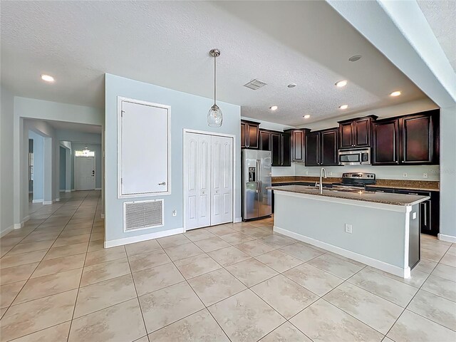 15150 Evergreen Oak Loop, Winter Garden, FL 34787 - kitchen with appliances with stainless steel finishes, recessed lighting, light tile patterned floors, a textured ceiling, and hanging light fixtures