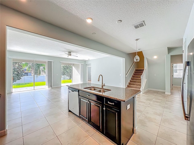 15150 Evergreen Oak Loop, Winter Garden, FL 34787 - kitchen with dishwasher, open floor plan, a textured ceiling, light stone counters, and an island with sink