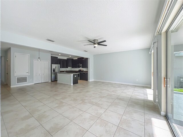 15150 Evergreen Oak Loop, Winter Garden, FL 34787 - unfurnished living room with ceiling fan, light tile patterned floors, and a textured ceiling