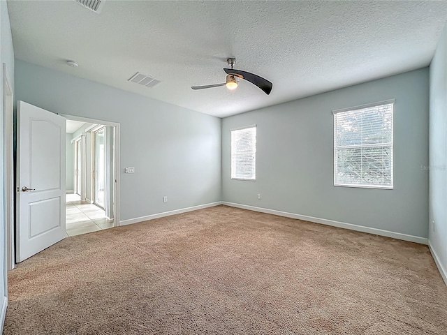 15150 Evergreen Oak Loop, Winter Garden, FL 34787 - unfurnished bedroom featuring light colored carpet, a textured ceiling, and a ceiling fan