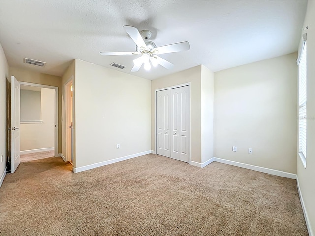 15150 Evergreen Oak Loop, Winter Garden, FL 34787 - unfurnished bedroom with carpet flooring, a closet, and a ceiling fan