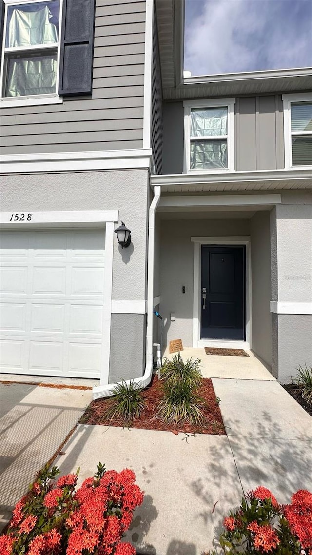 1528 Mirabella Cir, Davenport, FL 33897 - doorway to property featuring an attached garage and stucco siding
