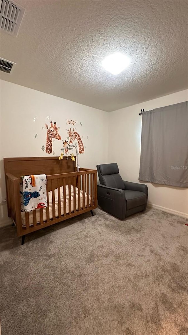 1528 Mirabella Cir, Davenport, FL 33897 - carpeted bedroom featuring a textured ceiling and a nursery area
