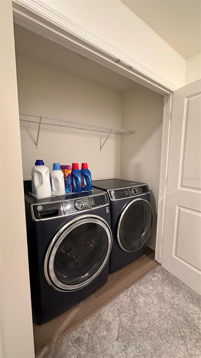 1528 Mirabella Cir, Davenport, FL 33897 - laundry area featuring separate washer and dryer and wood finished floors