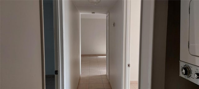 7429 Daniel Webster Dr Unit 13E Aka A, Winter Park, FL 32792 - hall with stacked washer / dryer and light tile patterned flooring