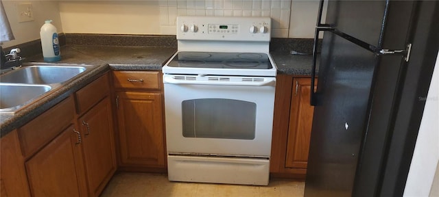 7429 Daniel Webster Dr Unit 13E Aka A, Winter Park, FL 32792 - kitchen with white electric stove, freestanding refrigerator, brown cabinets, dark countertops, and backsplash