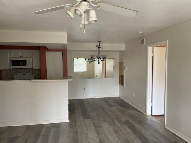3016 Parkway Blvd Unit 303, Kissimmee, FL 34747 - kitchen with white microwave, electric range oven, dark wood-style floors, ceiling fan, and a chandelier