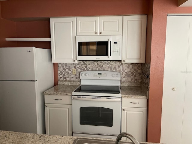 3016 Parkway Blvd Unit 303, Kissimmee, FL 34747 - kitchen with white appliances, tasteful backsplash, open shelves, and white cabinets