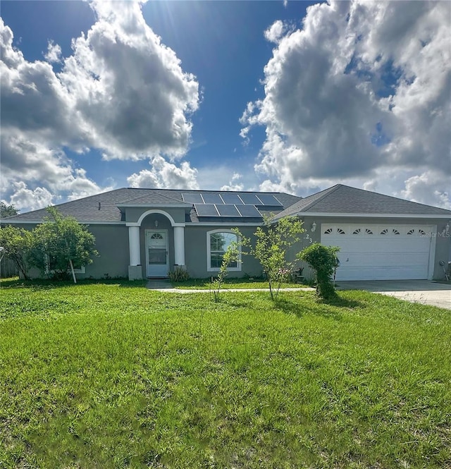 2333 Ainsworth Ave, Deltona, FL 32738 - ranch-style house with stucco siding, roof mounted solar panels, driveway, a front lawn, and a garage